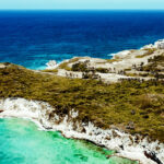 Aerial view of the turquoise coastline and luxury Punta Cana all inclusive resorts on a lush peninsula