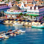Aerial view of a resort by the beach in Aruba, ideal for all inclusive trips.